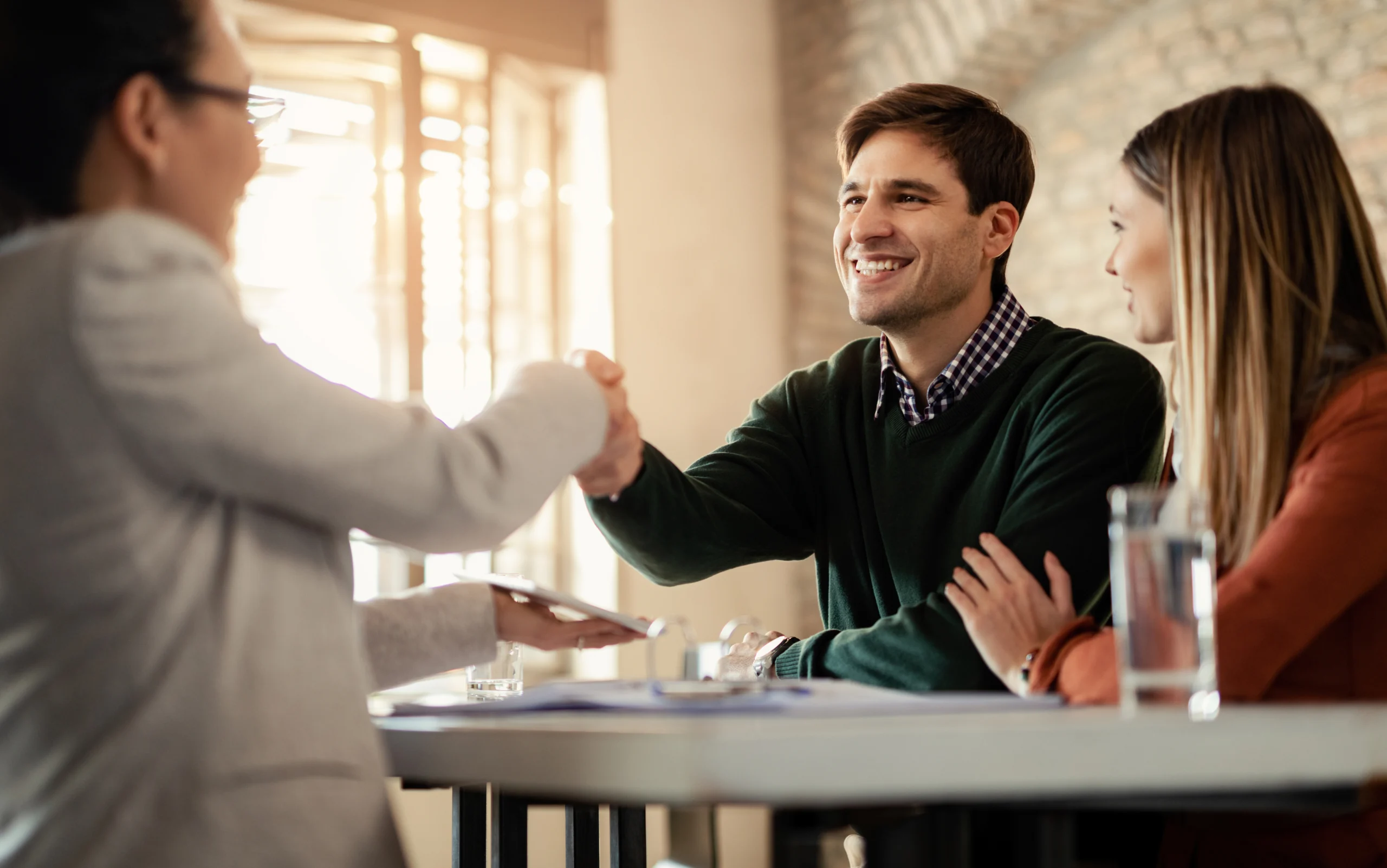 Business representatives shaking hands after a professional meeting